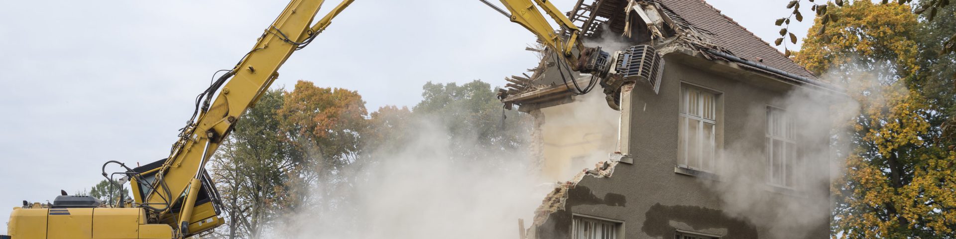 A digger demolishing houses for reconstruction.